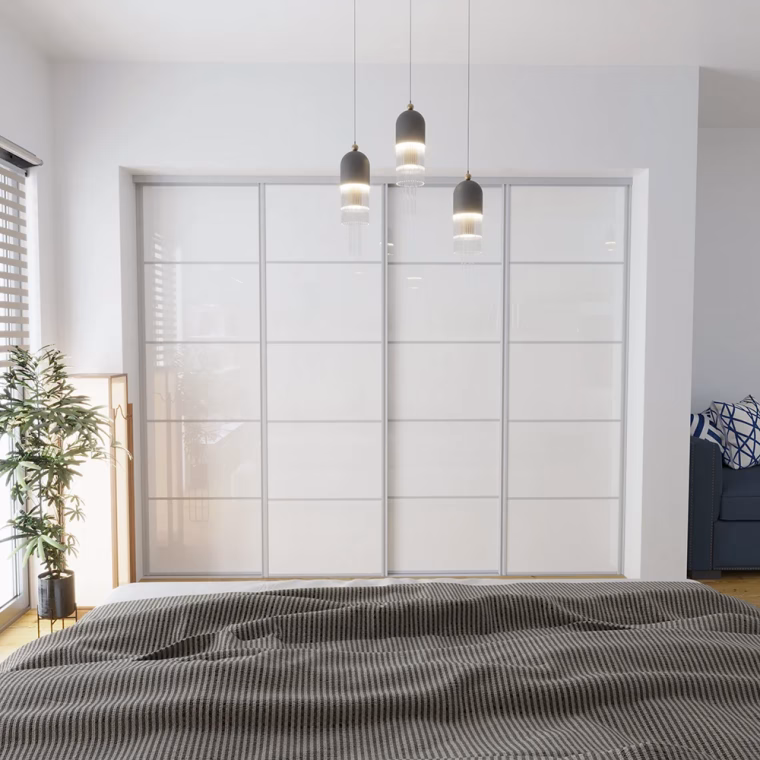 Flat-pack sliding wardrobe doors in white and installed in a modern bedroom